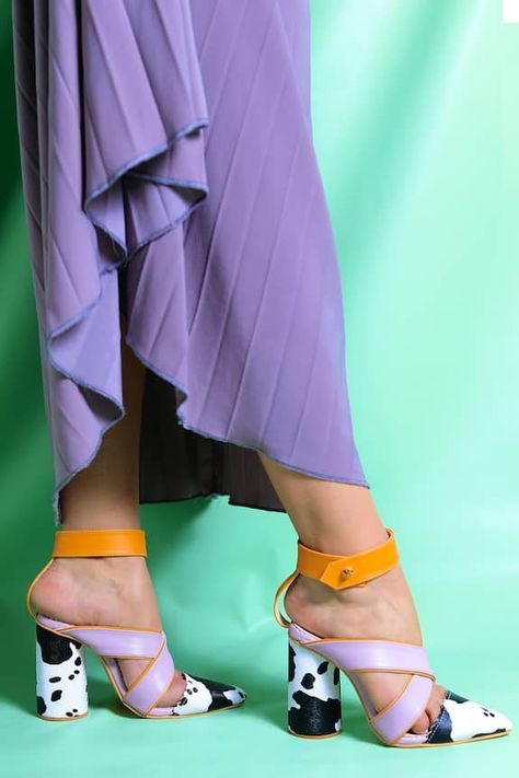 Multicolor block heels with cow print, orange ankle band and a lilac criss-cross straps.
Type: Print
Composition: Vegan Leather 
Color: Multi Color
Cylindrical shape heels
Heel Height (inch): 3
Closure: Ankle strap
Note: The slip on heels shown in the image are not for sale - Aza Fashions Color Block Heels, Footwear Fashion, Bride Outfits, Heel Accessories, Heels Online, Exclusive Shoes, Chic Shoes, Mens Designer Fashion, Pointed Toe Heels