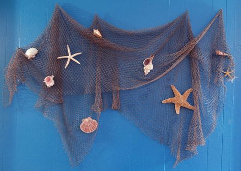 Fisherman Net Decoration | Fish net hung on blue wall decorated with seashells and starfish. Fishing Net Wall Decor, Fish Net Decor, Nautical Bathroom Decor, Beach Theme Bathroom, Nautical Bathrooms, Beach Room, Sea Decor, Sea Shell Decor, Fish Net