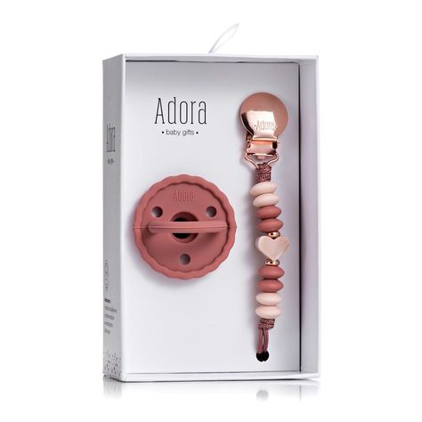 The Adora Baby Gifts Pacifier Set - The favored pacifier by mom’s and babies alike. With its natural soft and flexible silicone material it provides the feel of mom, allowing the baby to self-soothe and remain calm. The Adora Baby Gifts pacifier’s iconic one-piece design assures the safety and cleanliness of the product. Capture the pure infant look with these lovable paci styles. Baby Soother, Teething Stages, Baby Boy Booties, Newborn Pacifier, Baby Wishlist, Remain Calm, Comfort Gifts, Layette Set, Boy Accessories