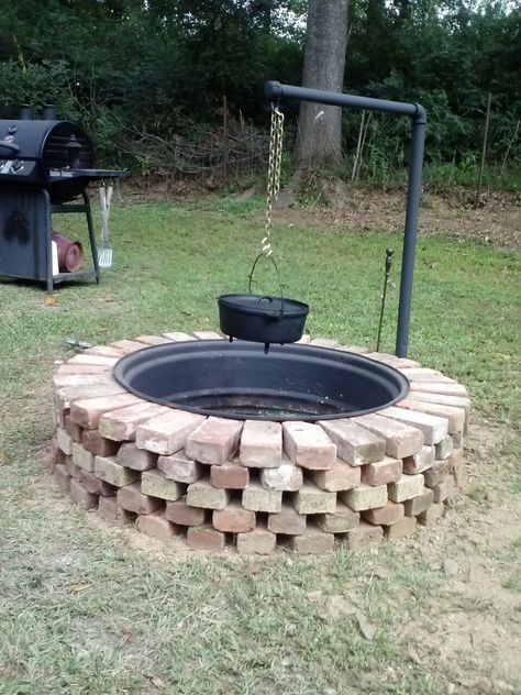 This is our Fire Pit made from tractor rim and reclaimed Bricks . Husband constructed swivel post to hang cooking pots on, so you can swing to the side. Great for cooking. Patio Layout Design, Cheap Fire Pit, Diy Keramik, Outside Fire Pits, Brick Fire Pit, Patio Layout, Outdoor Fire Pit Designs, Fire Pit Landscaping, Fire Pit Grill