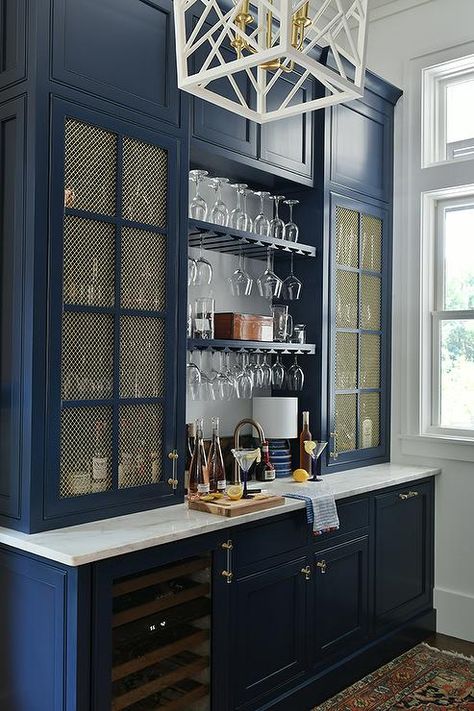 Kitchen features a blue butler's pantry with brass grill cabinet doors, blue cabinets with glass and brass pulls and a blue wine rack. White Kitchen Drawers, Wine Rack Design, Cabinet Glass Doors, School House Lighting, Home Bar Rooms, Built In Bar, Glass Front Cabinets, Coffee Bar Home, Blue Cabinets