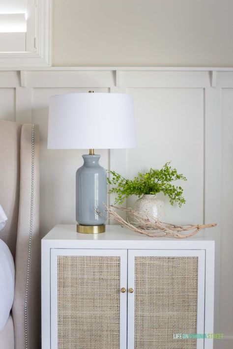 Coastal decor with a cane and white nightstand, side table lamp, and coastal decor. #decor #homedecor White Night Tables, Cane Nightstand Bedroom, Coastal Lamps Bedroom, Coastal Lamps, Wood Bead Chandelier, Usb Lamp, Fall Home Tour, Faux Greenery, Side Table Lamps