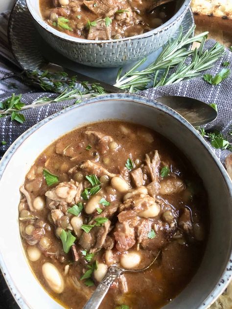 A rich slow-cooked casserole originating in the South of France, this White Bean Cassoulet with Pork & Lentils is a hearty bowl of goodness. Be sure to have some crusty bread handy for dipping in that delicious broth. A Hint of Rosemary #soups #stews #heartysoups #beans #lentils #pork #bacon #herbs #onepotmeal #ahintofrosemary White Bean Cassoulet, Bean Cassoulet, Pork Bacon, Lean Pork, Soups Stews, Cooking Basics, Slow Cookers, White Bean, 50 Style