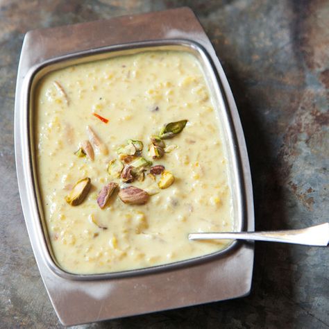 Kheer (Indian Rice Pudding)-- This traditional cardamom-scented Indian rice pudding owes its particular richness to the inclusion of whole milk, which has been reduced by half during the cooking process to produce a thick, creamy base. Indian Rice Pudding, Pomfret Fish, Rice Kheer, Coconut Rice Pudding, Kheer Recipe, Indian Rice, Custard Recipes, Restaurant Dishes, Fish Recipe