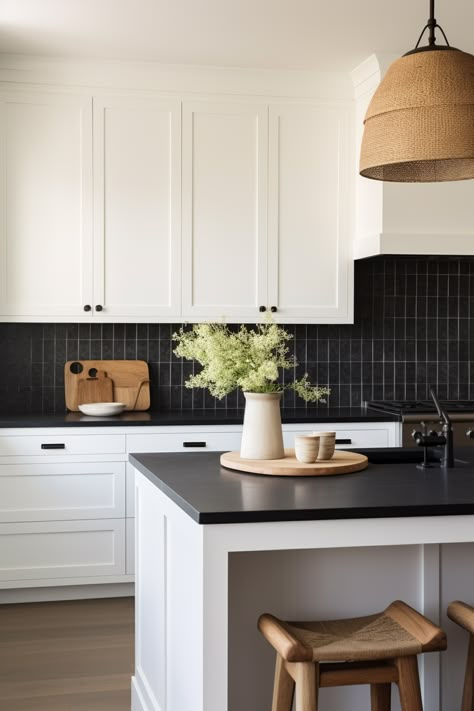 Black Tiles White Kitchen, Kitchen With Black Tiles Wall, White Cabinet With Black Backsplash, Condo Kitchen Black Countertop, White Backsplash Dark Countertop, White Kitchen Cabinets With Dark Backsplash, Black Kitchen Countertops And Backsplash, White Kitchen Black Walls, White Tiles Kitchen Wall