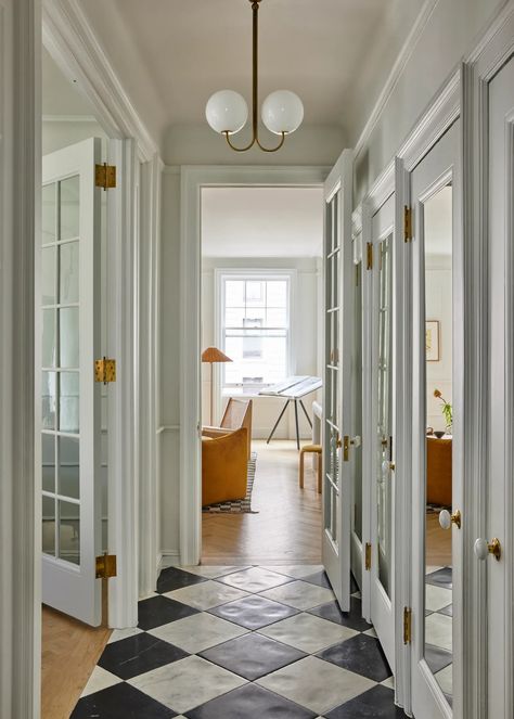 A Historic Upper West Side Apartment Remains Untouched, and That’s the Best Part | Architectural Digest Upper West Side Apartment, White Tile Floor, Warm Interior, Vintage Stool, Iconic Furniture, Black And White Tiles, Upper West Side, Paris Apartments, Nyc Apartment