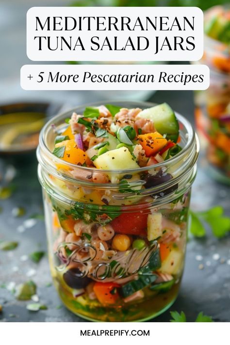 Colorful Mediterranean tuna salad jar packed with fresh veggies and chickpeas, showcasing a pescatarian recipe. Simple Summery Mediterranean Salad Jars, Mediterranean Jar Salad, Tuna Mediterranean Salad, Mediterranean Pescatarian Recipes, Mediterranean Tuna Recipes, Mediterranean Tuna Salad Recipe, Tuna Meal Prep, Healthy Pescatarian Recipes, Pescetarian Meals