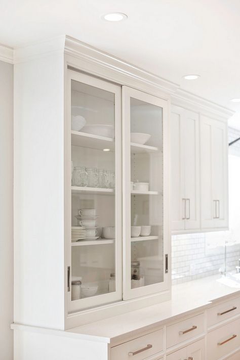 The perimeter cabinets are a warm white by Pennville called “Cottonball”. Notice the hutch with sliding doors. I’m loving this clean look!Modern Farmhouse Kitchen Design Kitchen Cabinets Sliding Doors, Kitchen Hutch Cabinet, Sliding Cabinet Doors, Architecture Renovation, Modern Sliding Doors, Shaker Style Cabinets, Diy Kitchen Renovation, White Cabinet, Farmhouse Kitchen Design