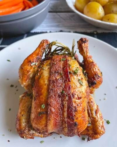 Enjoy bacon-wrapped air-fryer Cornish hens in just 35 minutes Air Fryer Cornish Hen Recipe, Air Fryer Cornish Hen, Cornish Game Hens, Cornish Hen Recipe, Game Hens, Cornish Hen, Holiday Roasts, Cornish Hens, White Plate