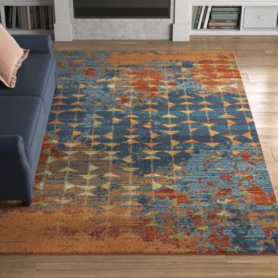 This indoor/outdoor area rug elevates your living room or deck with an abstract motif, bright colors, and boho style. It's power-loomed from wool and cotton, and it features distressed and geometric patterns in orange, blue, and gray-beige hues. With a high pile height, it's best for lower-traffic areas, such as your bedroom or home office. Best of all, this rug is stain-resistant, allowing it to stand up to the occasional spill and splash. We recommend adding a rug pad underneath to prevent sli Coral Abstract, Coral Area Rug, Living Room Orange, Abstract Area Rug, Watercolor Designs, Austin Design, Blue Coral, Blue Living Room, Orange Area Rug