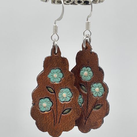 These are so fun and bright, great for spring and summer! Each design is hand tooled and then hand painted before we antique them. We have a few different colors in each design.  Our Silver colored ear hooks are Silver Plated and our Gold ear hooks are 18k Gold Plated. Painted Leather Earrings, Into The West, Hand Painted Leather, Hand Tooled Leather, Tooled Leather, Ear Hook, Leather Earrings, Leather Tooling, Hand Tools