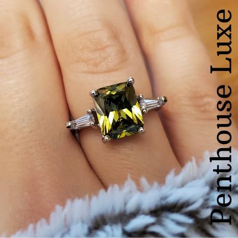 Brand New, Never Worn Green Peridot Ring From Penthouse Luxe. I Am Reposhing - This Ring Has Sat In My Jewelry Box And Is Just Ready For A New Home! Large Center Peridot Stone (3.8 Ct) With Two Tapered Baguette White Sapphires On Either Side. This Is A Sterling Silver Plated Band, Engraved S925. Size 6. Floating Diamond Ring, Peridot Rings, Brownish Green, Sapphire Silver Ring, Rose Gold Band Ring, Luxe Jewelry, Wedding Rings Solitaire, Peridot Stone, Tanzanite Ring