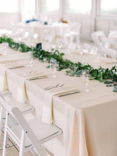 Wedding tablescape with white napkins and green florals Tablescapes Napkins, Buffet Style Wedding Reception, Unique Table Numbers Wedding, Napkins Wedding Table, Green Tablescape, Round Wedding Tables, Green Centerpieces, Green Napkins, Rustic Wedding Chic