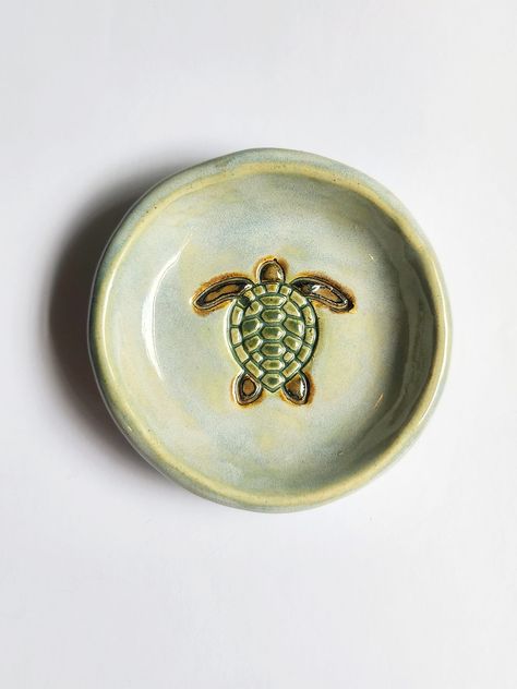 This small round sea turtle dish is made from a white highfire stoneware clay.  It measures 4" wide and is the perfect size for resting a tea bag or putting a side of dipping  sauce in.  The glazes are non-toxic,  leadfree, and foodsafe.  This dish is also microwave and dishwasher safe.  The photo above is a good representation of the dish you will receive. I take great care to make each of these dishes as similar as I can but they are each hand carved and painted and  minor glaze variations can