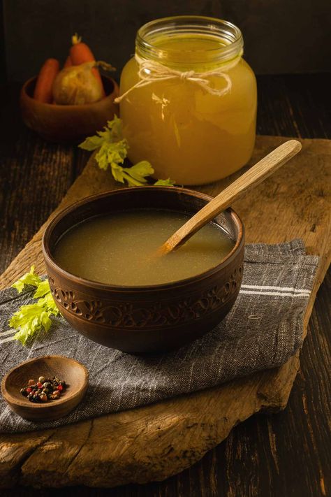 Golden yellow chicken feet bone broth in a big, carved brown bowl. In the background is a large mason jar full of more stock. Chicken Feet Bone Broth, Braised Kale, Large Mason Jars, Pressure Canner, Broth Recipes, Pressure Canning, Canned Chicken, Bone Broth, Oven Roast