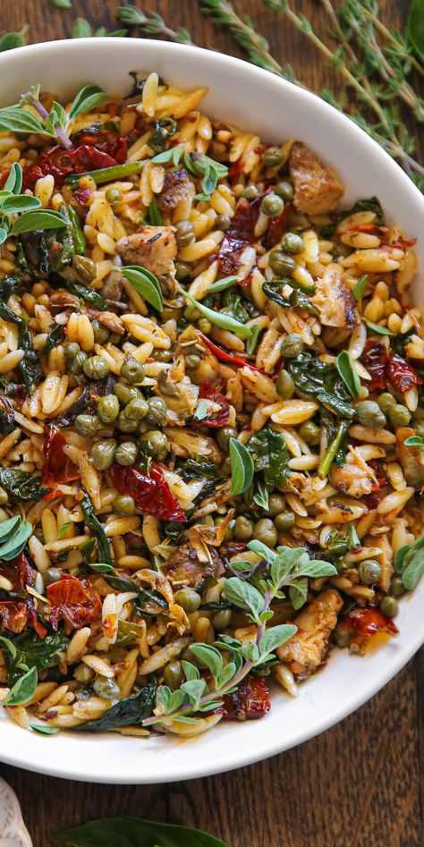 Spinach Orzo with Sun-Dried Tomatoes, Artichokes, and Capers - in a white bowl. Orzo With Capers, Mediterranean Diet Artichoke Recipes, Healthy Vegetarian Salads, Winter Orzo Salad Recipes, Leftover Orzo Recipes, Recipes For Dinner Healthy Vegetarian, Spinach Mushroom Orzo, Orzo Recipes Dairy Free, Veg Side Dish