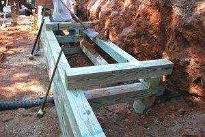 Wood Retaining Walls Peachtree City, Fayetteville, GA | Landscape Innovations Steep Gardens, Retaining Wall Steps, Wood Retaining Wall, Diy Retaining Wall, Backyard Retaining Walls, Rock Retaining Wall, Building A Retaining Wall, Landscaping Retaining Walls, Driveway Landscaping