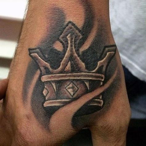 This is a tattoo that has a crown, which seems to be drawn over flames of fire. It could mean that the supremacy or dominance of the wearer is unshaken and never fades. It looks elegant on the back of the hand.  #tattoos #tattoofriday #tattooart #tattoodesign #crowntattoosdesign #simplecrowntattoos #crowntattoo #man'sfashion #kingcrowntattoo Crown Hand Tattoo, Steampunk Tattoo Design, Crown Tattoo Men, King Crown Tattoo, Small Crown Tattoo, Herren Hand Tattoos, Crown Tattoos, Best Neck Tattoos, Steampunk Tattoo