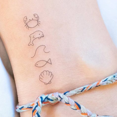 Minimalistic crab, dolphin, wave, fish and shell Mia Tattoo, Dolphin Tattoos, Partner Tattoos, International Tattoo, Simple Tats, Crab Tattoo, Stunning Tattoos, Dolphins Tattoo, Tiny Wrist Tattoos