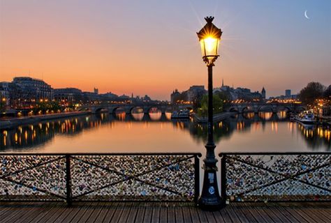 View from the Pont des Arts: Here you can enjoy a splendid view of the Louvre, Pont Neuf, Palace of Justice, the spire of Sainte-Chapelle and the towers of Notre Dame. According to me, the view by night is the best! Pont Des Arts Paris, Love Lock Bridge, Jardin Des Tuileries, Love Lock, Tourist Information, Street Lamp, Travel Images, Tour Eiffel, Street Light