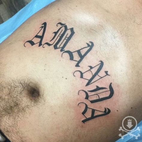 Old English Date Tattoo, Number Stomach Tattoos, Stomach Tattoos Men Writing, Old English Stomach Tattoo, Stomach Lettering Tattoos Men, Gothic Font Stomach Tattoo, Date Tattoos, Number Tattoos, Stomach Tattoos