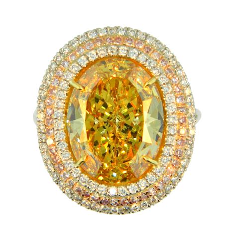 7.27ct Fancy Deep Brownish Yellow SI1 oval cut cocktail ring framed within a triple halo of white round brilliant cut diamonds and natural fancy pink round brilliant cut diamonds. Colored Diamond Jewelry, Brownish Yellow, Deep Yellow, Precious Rings, Gem Diamonds, Fine Art Jewelry, Bling Rings, Fancy Color Diamonds, Mellow Yellow