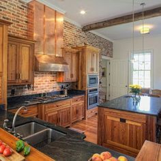 dark counters with brick back splash. Really like the brick look. Farmhouse Traditional Kitchen, Oven Hoods, Kitchen Window Bar, Backsplash Herringbone, Hickory Kitchen, Hickory Cabinets, Cheap Countertops, Black Countertops, Brick Backsplash