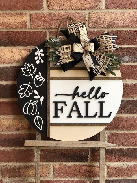 We offer a wide variety of wooden door hangers to spruce up your front door!  Description: Welcome the cozy vibes of autumn with our stunning Hello Fall Door Hanger, perfect for adding a touch of warmth and charm to your front door! Handcrafted with care, this door hanger is available in two sizes, 18" and 22", and features high-quality materials and craftsmanship. Product Features: Sizes: Choose between 18 inches and 22 inches in diameter. Thickness: Sturdy 1/2 inch thickness for durability. 3D Fall Round Wood Signs Diy, Diy Fall Door Hangers, Fall Door Signs, Welcome Wood Sign, Round Signs, Fall Door Hanger, 3d Lettering, Door Signs Diy, Circuit Ideas