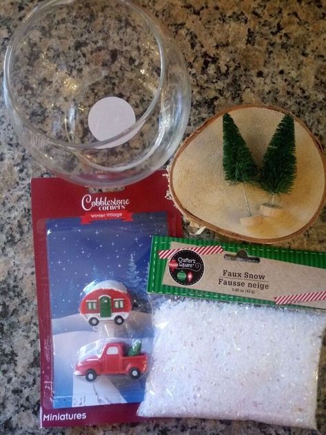 These budget friendly snow globes are made primarily with Dollar Tree items! These are perfect for shelf or mantel decor, gifts for friends and family, or just a fun afternoon craft with children. Supplies To make these snow globes you will need some kind of glass votive, festive miniatures, bottle brush trees, faux snow and a base of some sort. I used a wood slice. Wood slices can be found right in your backyard for free! If you do not have any sufficient branches in your yard to uti… Dollar Tree Christmas Snow Globe, Dollar Tree Snow Globe Ideas, Dollar Tree Snow Globes Diy, Diy Dollar Tree Snow Globe, Dollar Tree Snow Globes, Christmas Glassware, Market Crafts, Senior Crafts, Afternoon Crafts