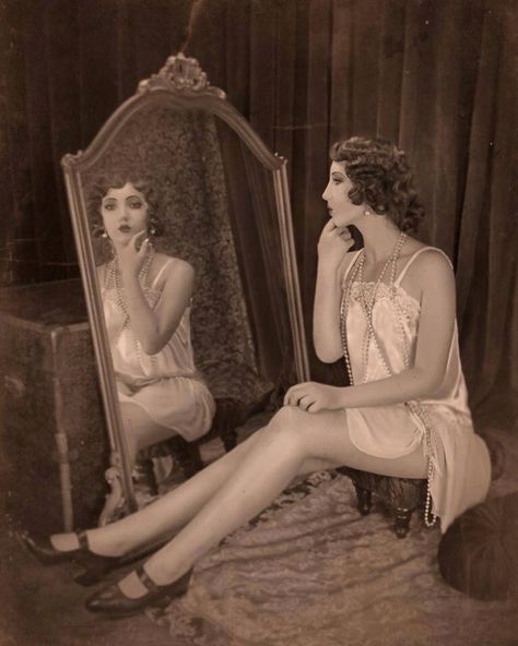 Sitting At Vanity Pose, Woman Looking In Mirror Painting, Looking In Mirror Pose Reference, Woman Looking In Mirror Art, Person Doing Makeup In Mirror, Mirror Reference Pose, Vintage Mirror Photoshoot, Standing In Front Of Mirror Reference, Woman Doing Makeup In Mirror