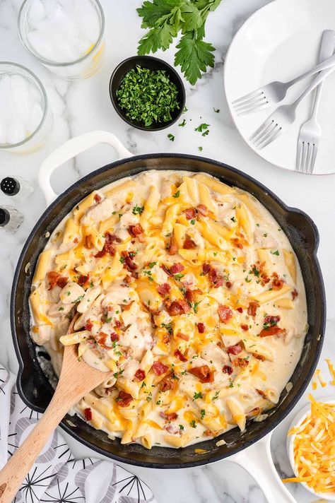 Crack Chicken Penne on a white table with parsley and cheese on the side. Chicken Penne, Princess Pinky Girl, Pinky Girl, One Pot Pasta Recipes, One Pot Pasta, Chicken Casserole, Boneless Skinless Chicken Breast, Cream Of Chicken Soup, Chicken Pasta