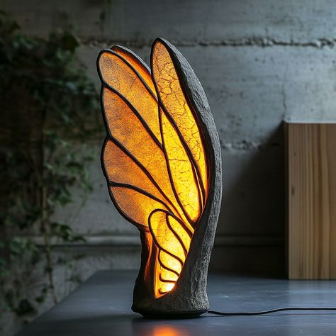 This lamp, inspired by the delicate structure of insect wings, brings a touch of nature’s elegance into your home. The lampshade mimics the intricate patterns found in the wings of dragonflies or butterflies, with translucent panels that softly diffuse light, creating a warm and inviting glow. The design features a lightweight, airy frame that captures the fragility and grace of the natural world, while the lamp’s organic curves and subtle textures evoke the sense of being surrounded by natur... Parametric Lighting, Foldable Ideas, Cool Sculptures, Unique Pic, Neon Decorations, Butterfly Lamp, Lamp Inspired, Insect Wings, Tree Lamp