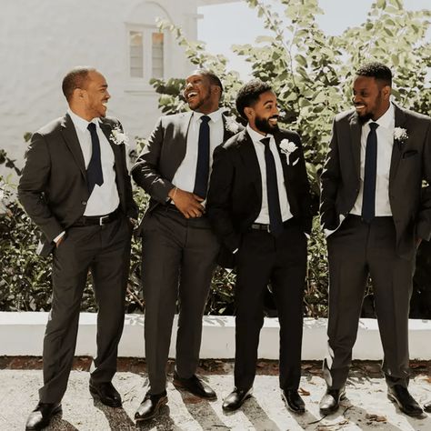 Dressing for a spring wedding can feel a little confusing. As the winter chill thaws off, temperatures outside tend to be a bit up in the air (think cooler evenings and warmer afternoons), leaving you unsure of exactly what kind of suit to put on. Overall, though, you want your spring wedding suit to be lighter and maybe more colorful than the kind... Charcoal Groomsmen, Dark Grey Groomsmen, Male Wedding Guest Outfit, Gray Groomsmen Suits, Grey Suit Wedding, Casual Grooms, Groomsmen Grey, Grey Suit Men, Dark Gray Suit