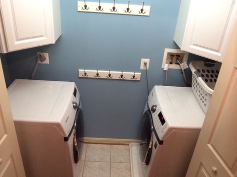 A simple solution to a small upstairs laundry closet. The HE washers were too big for the sliding doors when they faced forward, so we turned them sideways and added corner upper cabinets for storage. Multiple hooks were added for hanging clothes to dry. Washer Dryer Facing Each Other, Face To Face Washer And Dryer, Washer And Dryer Across From Each Other, Washer And Dryer Facing Each Other, Hanging Clothes To Dry, Cabin Laundry Room, Laundry Room Supplies, Laundry Room Storage Solutions, Apartment Laundry