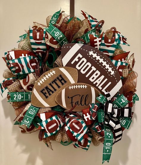 This Football inspired wreath is full and packed with various football designed ribbon. Mesh tubing added and also a sturdy wood sign. Great for your front door for football season or for a gift for that special football enthusiasts. Ready to ship and will ship quickly! Wooden Football, Football Wreaths, Sports Wreath, Homecoming Garter, Sports Wreaths, Football Signs, Football Wreath, Man Cave Gifts, Flower Arrangements Diy