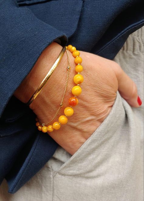 One of a kind yellow amber bracelet with tiny gold-plated steel spacer beads and lobster clasp. I have used beads from an old family amber necklace that had different sized beads and I made 3 different bracelets. This one has 6 mm beads in the middle, continuing to smaller, 4-3 mm beads at the ends. The collor varies through the beads from vibrant yellow to caramel with some darker spots, all natural for the amber stone. The length is 20 cm. Amber Bracelet, Amber Necklace, Amber Stone, Spacer Beads, Stone Beads, Amber, Caramel, Favorite Jewelry, Jewelry Bracelets