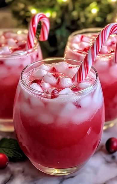 Ingredients:  4 cups cranberry juice, chilled 2 cups peppermint soda, chilled 1 cup pineapple juice, chilled 1 liter lemon-lime soda, chilled 6–8 mini candy canes, crushed (plus extra for garnish) Ice cubes Fresh cranberries (for garnish) Fresh mint leaves (for garnish) Instructions:  In a large punch bowl, combine cranberry juice, peppermint soda, and pineapple juice. Stir well. Slowly pour in lemon-lime soda for a fizzy touch. Stir in crushed candy canes, letting them dissolve slightly. Add ice cubes to keep the punch cool. Garnish with cranberries and mint leaves, and hook a candy cane on each glass. Mini Candy Canes, Christmas Punch, Lemon Lime Soda, Themed Drinks, Lime Soda, Candy Cane Christmas, The Punch, Fresh Mint Leaves, Fresh Cranberries