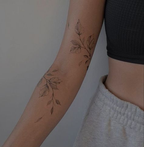 Tattoos Wrist Wrap Around, Around The Arm Flower Tattoo, Womens Family Tattoos, Floral Leaf Wrap Tattoo, Marigold Wrap Around Tattoo, Floral Shoulder Cap Tattoo Fine Line, Dainty Vine Tattoo Arm, Unique Wrap Around Tattoo, Floral Biblical Tattoo