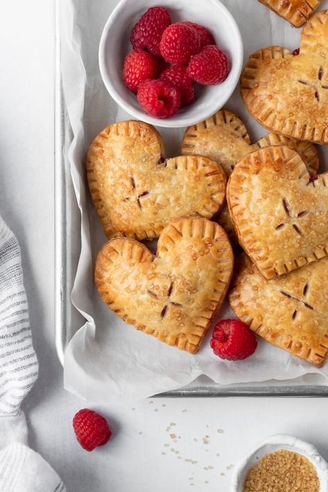 Raspberry Heart Hand Pies Heart Shaped Hand Pies, Raspberry Jam Puff Pastry, Heart Hand Pies, Raspberry Hand Pies, Pastry Folding, Berry Hand Pies, Heart Tarts, Prom Food, Raspberry Pastry