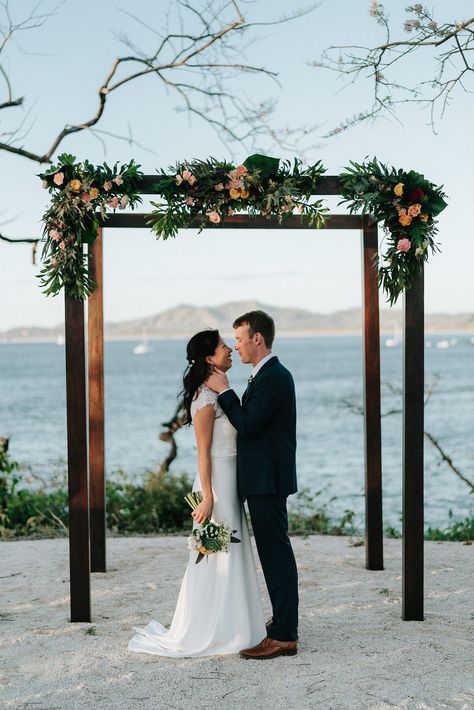 4 posted wedding arch with floral and garland accents Cornfield Wedding, Wooden Wedding Arches, Hand Furniture, Modern Floral Design, Costa Rica Wedding, Diy Trellis, Ceremony Decor, Wooden Wedding, Post Wedding