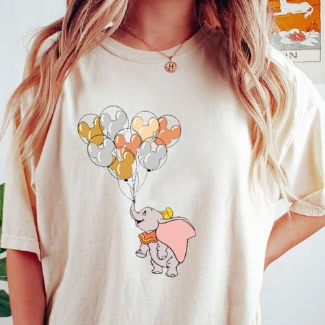 Exclusive deal alert! Dumbo with Mickey Balloon T-Shirt, Dumbo Shirt,Family Matching Tee , Magic Kingdom Shirt, available for a limited time at the incredible price of $22.00 #DumboShirt #ThePrincess #UnisexTShirt #MagicKingdom #DisneylandMatching #TheFrogShirt #KidTShirt #DisneylandTripTee #TianaShirt #HoodieSweatshirt Cute Disney Shirts, Magic Kingdom Shirt, Disney T Shirts, Matching Disney Shirts, Mickey Balloons, Mom Sweater, Soft Cute, Disney Tees, Matching Tees