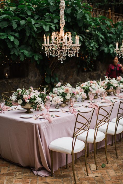 We are obsessed with this romantic wedding tucked away in one of Maui's hidden gems. This Hawaiian wedding venue, with glamorous hanging chandeliers, is a little slice of heaven and when the bride added hues of mauve, our hearts skipped a beat. Pink Forest Wedding, Pink Glam Wedding, Wedding Decor Blush Pink, Romantic Tablescape, Haiku Mill Wedding, Coastal Weddings, Velvet Tablecloth, Wedding Velvet, Shades Of Mauve