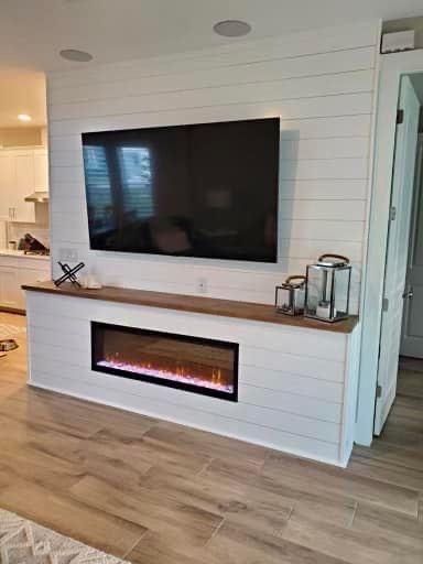 Fireplace Mounted On Wall, Farmhouse Living Room With Electric Fireplace, Electric Fireplace For Small Living Room, Fireplace Tv Wall Board And Batten, 3 Sided Linear Fireplace Ideas, Electric Fireplace Under Window, Wet Bar With Tv Above, Rustic Electric Fireplace Ideas With Tv, Low Fireplace Mantle With Tv