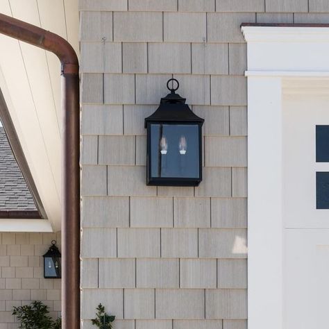 marika olson interiors on Instagram: "The sun reflecting of the copper gutters, warm gray shingles and climbing roses hits just right 😌  Builder: @hawkerconstruction  Landscape Designer: @chelseacorinnestudio  Photography: @charlotteleaphotography   #exterior #homeexterior #garage #garagedoor #sconces #outdoorsconces #exteriorsconces #exteriorlighting #landscapedesign #landscape #homeentry #entry #landscaping #roses" Copper Gutters Red Brick House, House With Copper Gutters, Cooper Exterior Lights, Exterior Copper Light Fixtures, Copper Gooseneck Exterior Light, Copper Gutters, Grey Houses, Outdoor Sconces, Climbing Roses