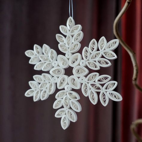 QUILLED PAPER SNOWFLAKE ORNAMENT Stunningly detailed quilled paper ornament to add beauty and festive spirit to your home. Perfect for someone who appreciates detailed and intricate paperwork by skilled artist. Quilling involves the use of paper strips that are curled in different sizes, manipulated into different shapes and glued together. As this is a handmade piece, it may differ slight from the photo.  # Ideas for use --------------------------------------------------------- * Hang it on a Christmas tree * Hang it on a window * Hang it on a dried flower bouquet * Hang it on dried branches * Add it to a wreath or garland * Give as a gift # Specification ---------------------------------------------------------- * Handmade from 5mm quilling paper * Warm white * Measures 12 cm/4.72 inch a Quilling Cross, Mandala Snowflake, Quill Art, Quilling Snowflakes, Quilling Inspiration, Quilled Snowflakes, Snowflake Paper, Christmas Quilling, Paper Quilling Tutorial