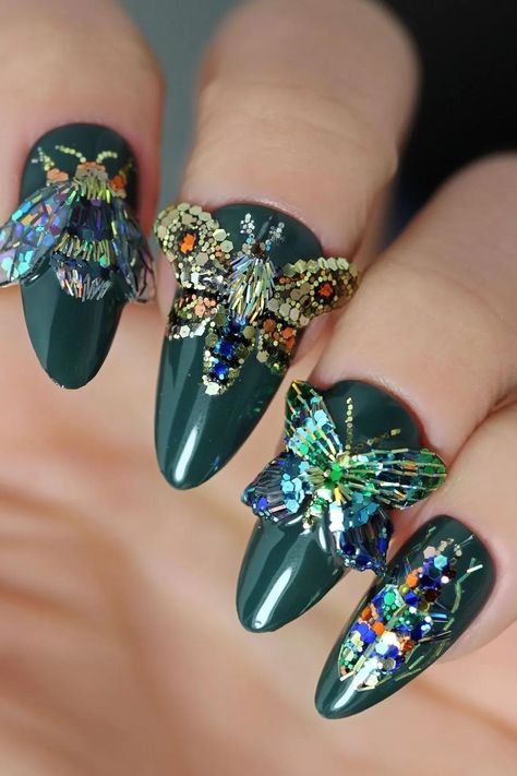 Glamour takes flight with these dark green stiletto nails adorned with dazzling butterfly gem embellishments, showcasing an opulent array of gold, silver, and multicolored rhinestones. Sparkling like delicate wings, these three-dimensional beauties capture every glimmer of light, bringing elegance and extravagance right to your fingertips.✨ // Photo Credit: Instagram @glitterfingersss Dark Green Stiletto Nails, Green Stiletto Nails, Cute Butterfly Nails, Butterfly Nail Ideas, Butterfly Nails, Butterfly Designs, Butterfly Nail, Cute Butterfly, Nails Inspo