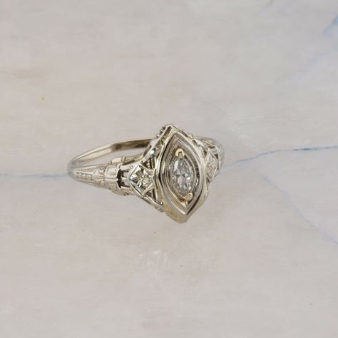 Antique 18K White Gold Marquise Diamond Art Deco Ring, pierced designs floral engraved, 5 x 2.5mm center marquise diamond, FVS, .5 inch across, Ring size 7.5, Circa 1930, 2.2 grams Stock # BB331R13 Most rings are sizable for a small fee. If the ring you are considering is the incorrect size contact us for a quote. This listing contains photographs of the actual item you will receive.  Our items are in excellent condition with little or no signs of wear and many are one of a kind pre-owned estate finds.   Please look closely at the pictures in this listing as they are part of the product description. Please read the description, as any imperfections or condition comments will be included.  We do our best to accurately describe the condition of each piece and encourage you to ask questions p Silver Art Deco Ring, Antique Engagement Rings Silver, Antique Engagement Rings Victorian, Diamond Art Deco Ring, Victorian Engagement Rings, Ivory Gown, Cute Engagement Rings, Vintage Engagement Rings Unique, Antique Wedding Rings