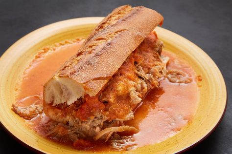 I'm hearing from some of you that you like carnitas in your tortas. I've got you covered with Tortas Ahogadas, or "drowned tortas." They have copious amounts carnitas stuffed into a crusty birote that is then smothered in a warmed, mild tomato sauce & topped with a warm spicy tomato salsa. Pati's Mexican Table Recipes, Patti Jinich Recipes, Tortas Sandwich, Patis Mexican Table, Pati Jinich, Mexican Table, Mexican Kitchens, Tex Mex Recipes, Latin Food