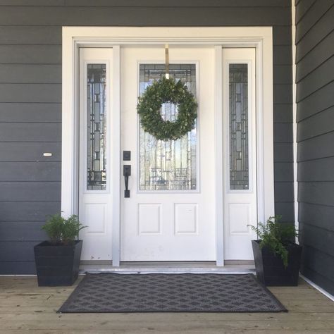 Grey Hardy Board Siding with white door. Ferns in planters on either side of door. Lovely farmhouse wreath and grey rug. (From blog Valley + Birch) White Door Decoration Ideas, White Exterior Doors, Ferns In Planters, White Door Exterior, White Front Door Exterior, White Entrance Door, Door Trim Styles, Leadlight Doors, Hardy Board Siding