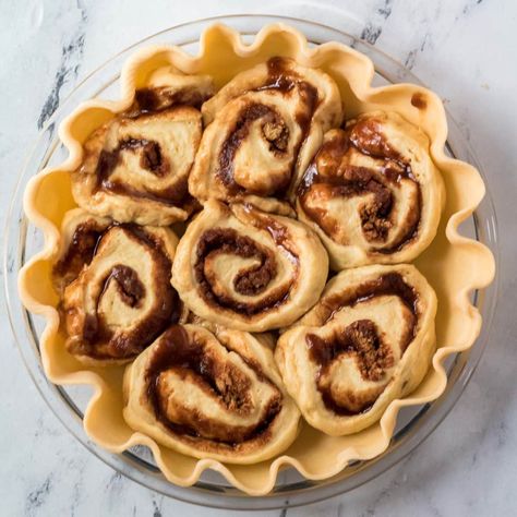 Cinnamon roll pie is an amazing breakfast or dessert treat with warm and gooey cinnamon rolls baked inside a flakey pie crust and covered is a sweet cream cheese frosting! Made with homemade from scratch cinnamon rolls this is a crowd pleasing dessert that everyone will love. Scratch Cinnamon Rolls, Cinnamon Roll Pie, Cracker Barrel Copycat, Cracker Barrel Copycat Recipes, Flakey Pie Crust, Premade Pie Crust, Gooey Cinnamon Rolls, Cinnamon Roll Bake, Store Bought Frosting